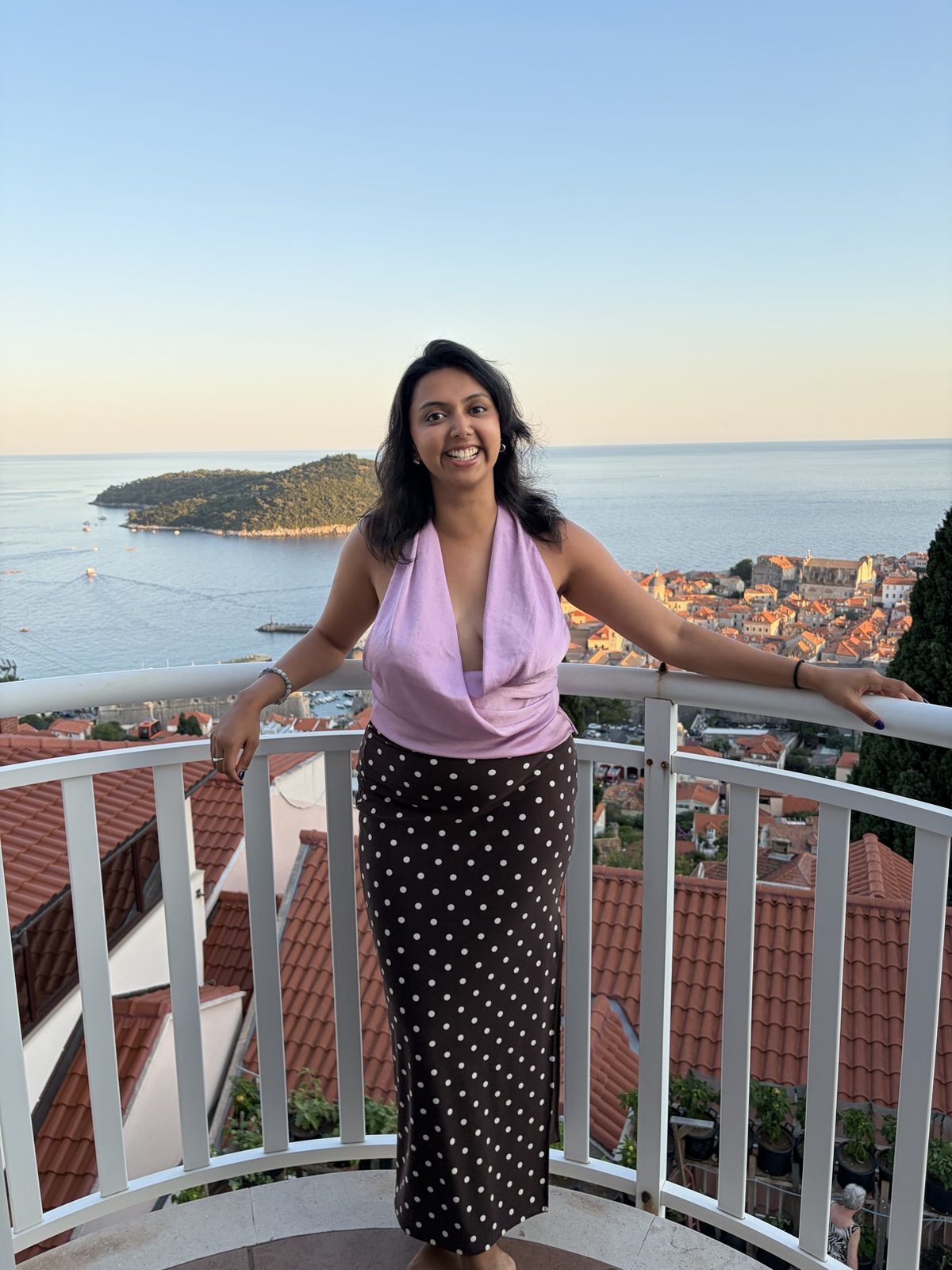 Anmol on a balcony in Dubrovnik at sunset
